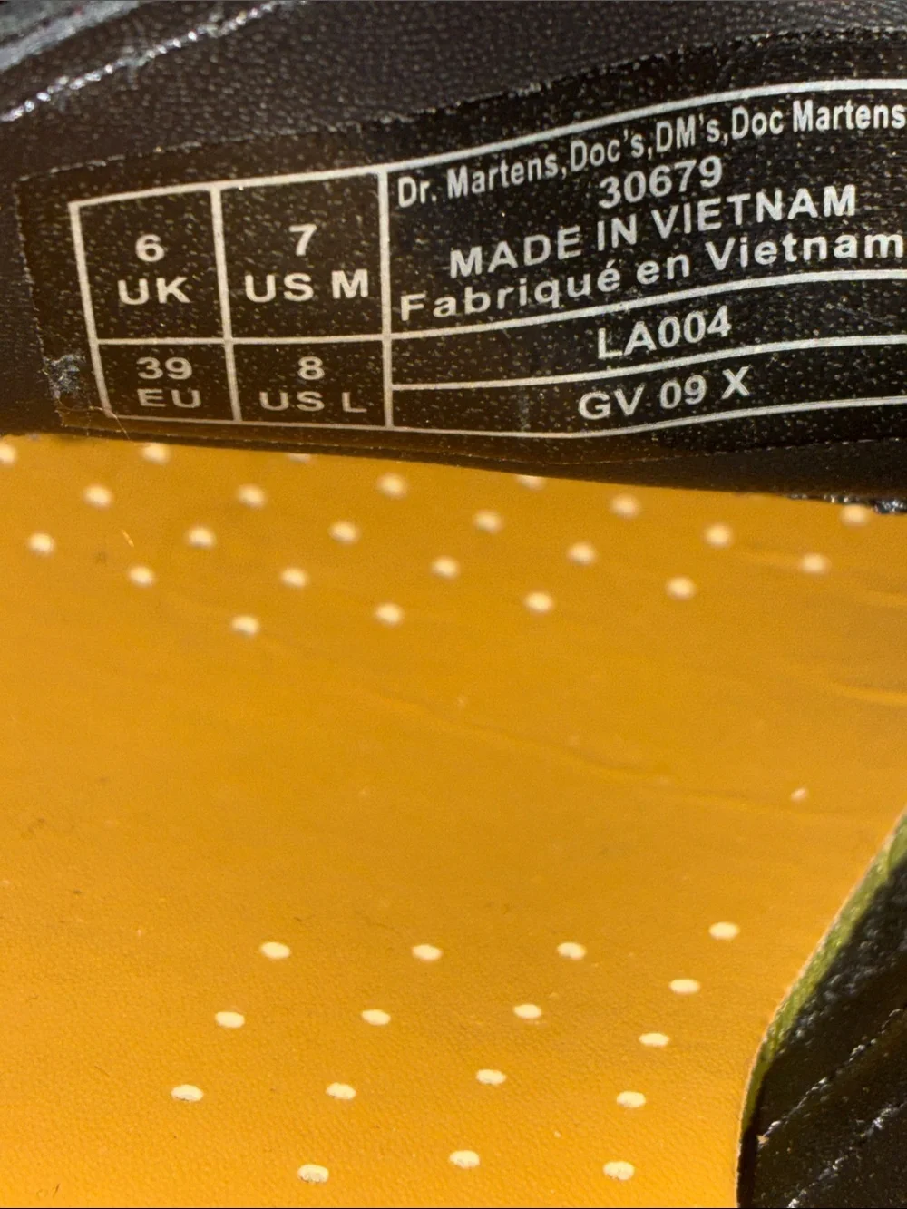 Dr. Martens 1461 leather oxfords feature the brand's signature yellow size 8